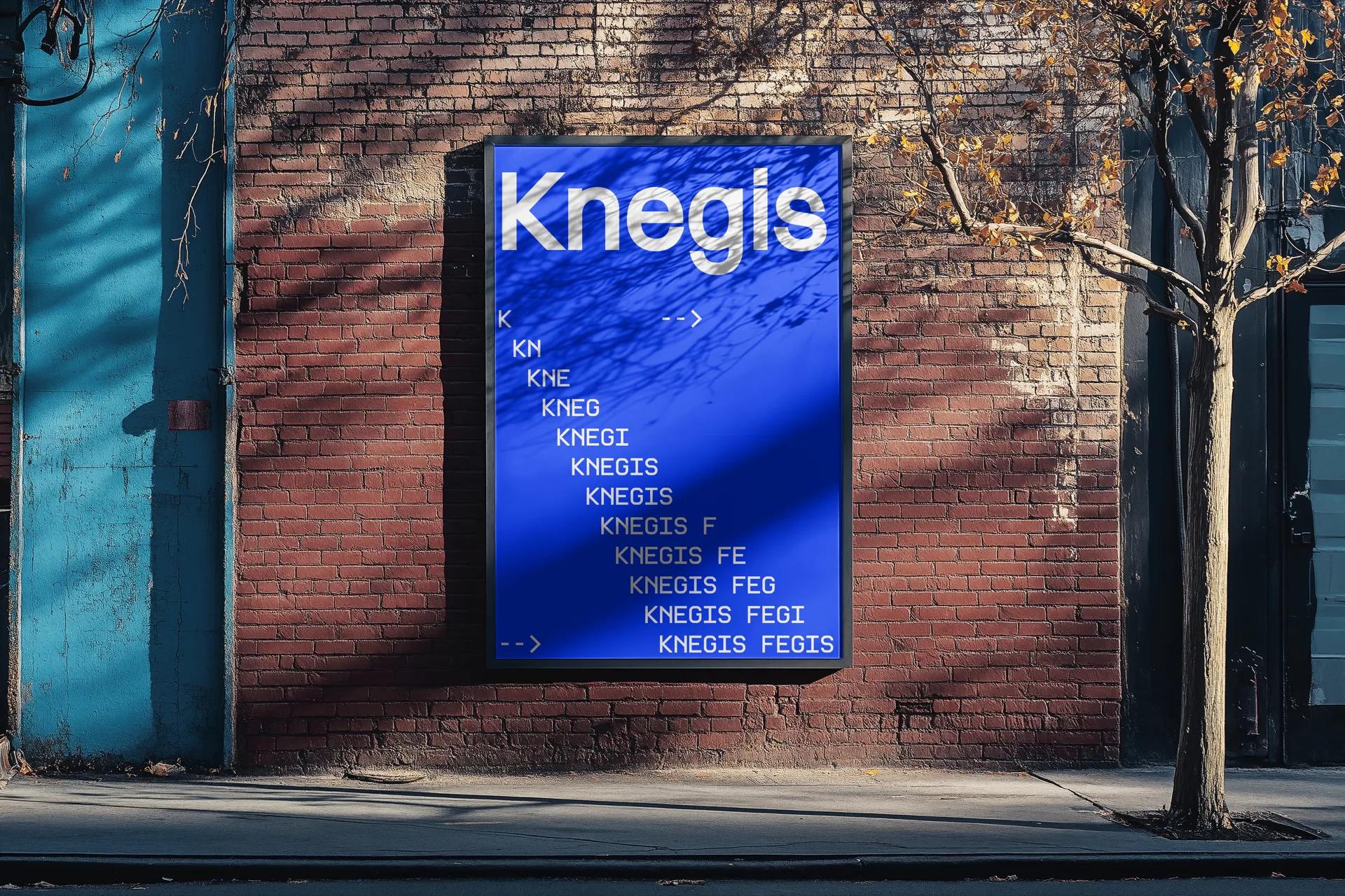 A Knegis poster mounted on a brick wall: the wordmark in white on deep blue, above a stepped column of monospace type spelling out KNEGIS FEGIS one letter at a time
